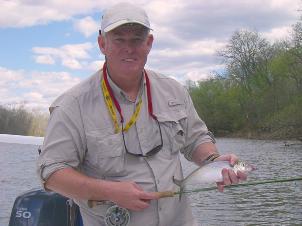 Clark Hutchison releasing fly caugth Shad