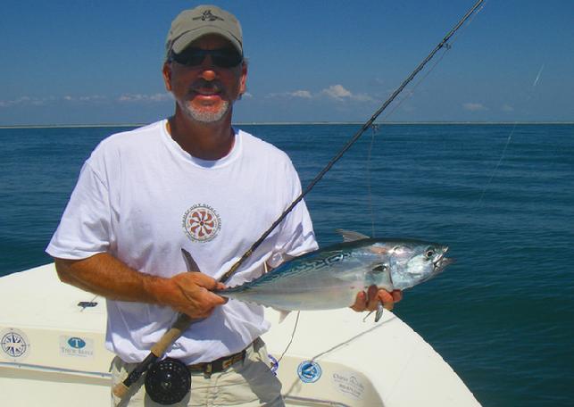 Doctor Cas Cader releasing Albie caught n Fly aboard vessel, "Fly Reel", Cape Lookout area of North Carolina
