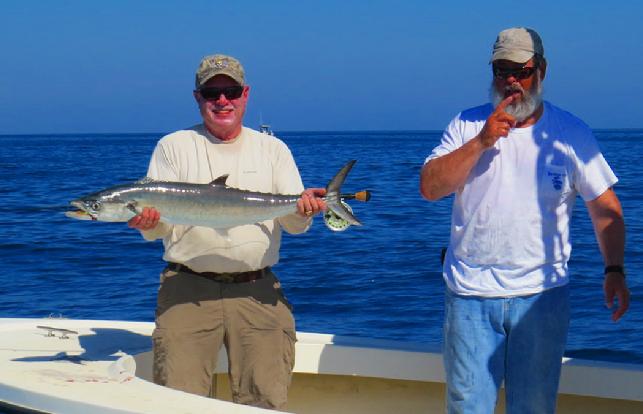 Angler John Langdon with Captain Joe Shute releasing fly caught Kingfish October 28 2014